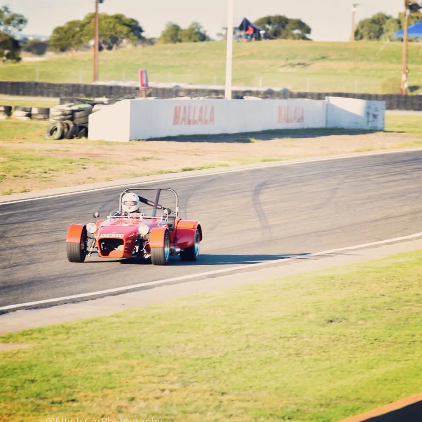 Andrew Mitchell racing a red sports car at Mallala, photographed by ElliotsCarPhotography